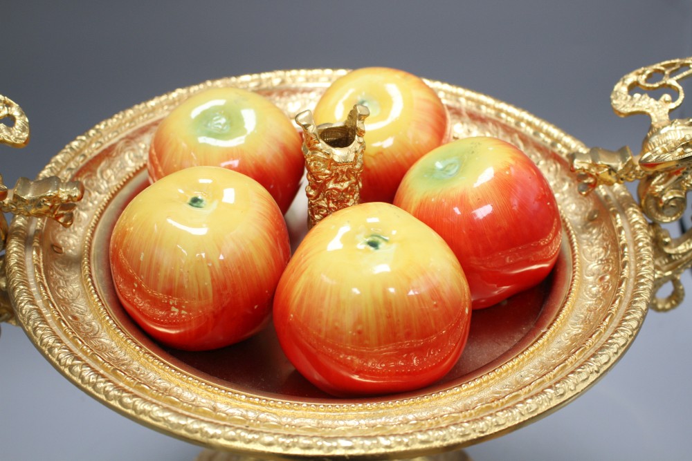 An Italian ornate gilt metal centrepiece, with five ceramic apple ornaments, width 46cm height 34cm